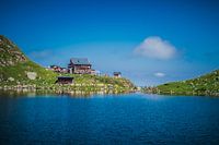 Mountain hut in the Alps by a lake