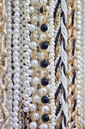 Close-up of hanging strings of glamorous white pearls 1