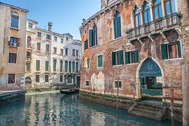 A gondola ride in Venice under a blue sky