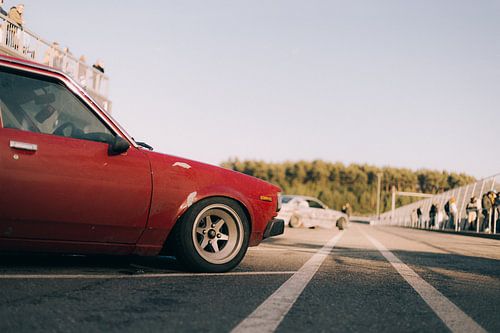 Roter Toyota Corolla Oldtimer Seitenansicht bei Sonnenuntergang