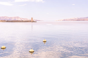 Pastel-coloured Adriatic with mountains and buoys