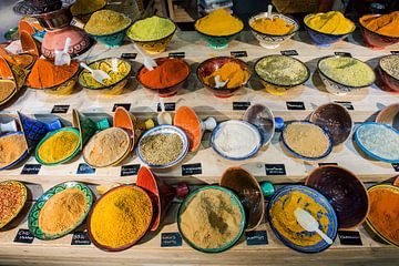 Colourful spices in tagine by Blond Beeld