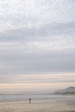 Misty sky on vast beach by Marit Hilarius