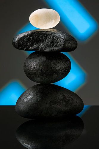 Three black stones with a glass stone