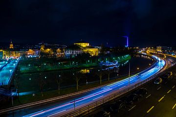 Deutschland, Magischer Nachthimmel über Dächern und belebter Autobahnstraße von von Simon Dux
