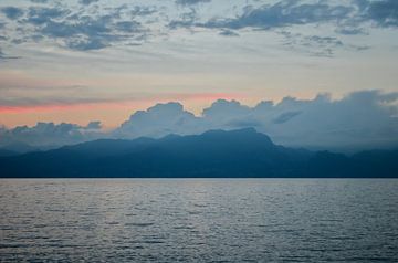 Sunset, lake, mountains and clouds.