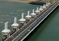 Coastal marathon runners pass the Eastern Scheldt storm surge barrier
