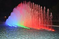 regenboog waterfontein in het donker van de nacht