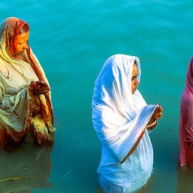 Three women praying (puja) in the Ganges near Varanasi, India by Jan Fritz