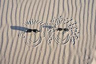 faces drawn in the sand on the beach of the Baltic Sea by Martin Köbsch thumbnail