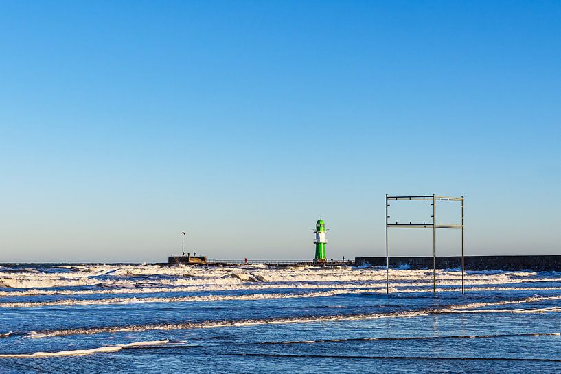 Waves and pier tower on the coast of the Baltic Sea in Warnemünde by Rico Ködder