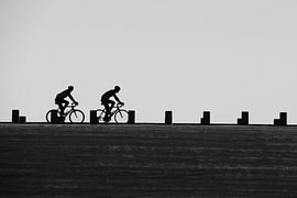 Cyclists on the dam by Erik Buitenhuis
