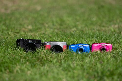 4 camera's in the grass by Marco van den Arend