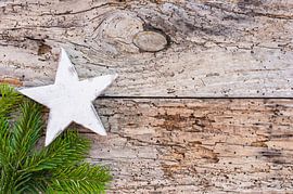 White wooden christmas star with green fir tree branch by Alex Winter