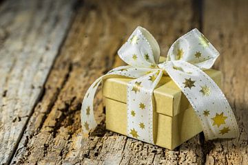 Geschenk mit weißem Stern geformt Schleife auf Holztisch Hintergrund von Alex Winter
