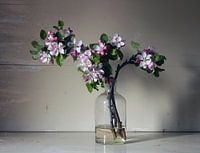 Glass bottle with apple blossom