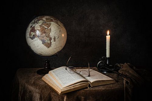 still life candle, book and globe