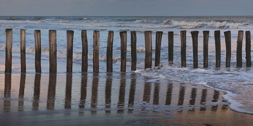 Breakwaters just after sunrise on the beach of Cadzand by Marjolijn van den Berg
