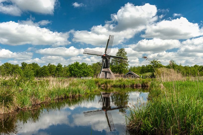 Dutch cloudy skies with a windmill by Fotografiecor .nl