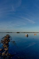 Travel photography - calm sea with rocks and two boats