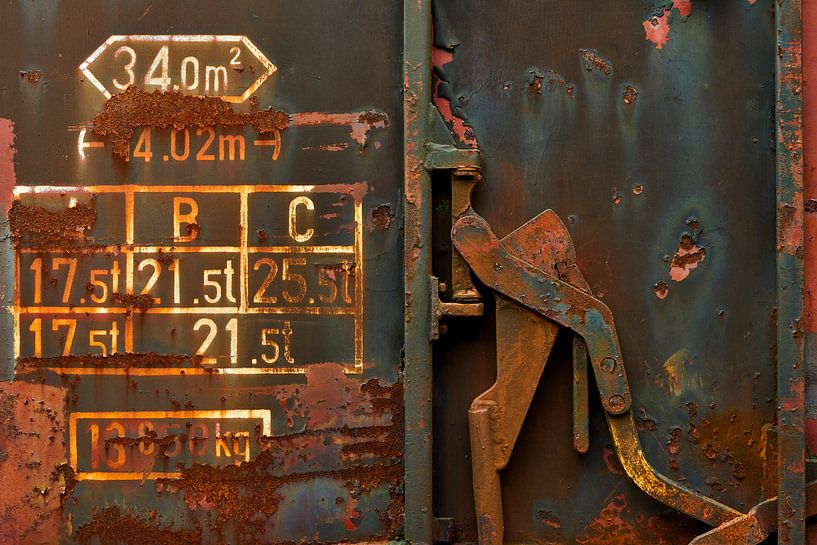 Door handle and text on old rusty railway car by Jenco van Zalk
