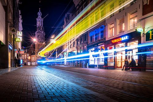 Tram traffic in front of the Munttoren in Amsterdam at night