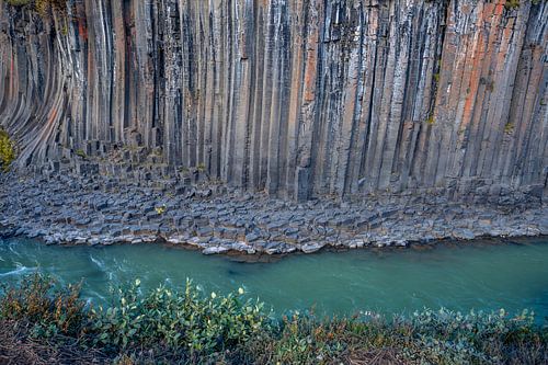 Basalt columns coloured orange by iron oxide, Studlagil Canyon, Egilsstadir, Austurland, Iceland