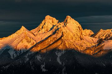 Red shining mountain in Tirol at sunrise. In winter with snow in the morning
