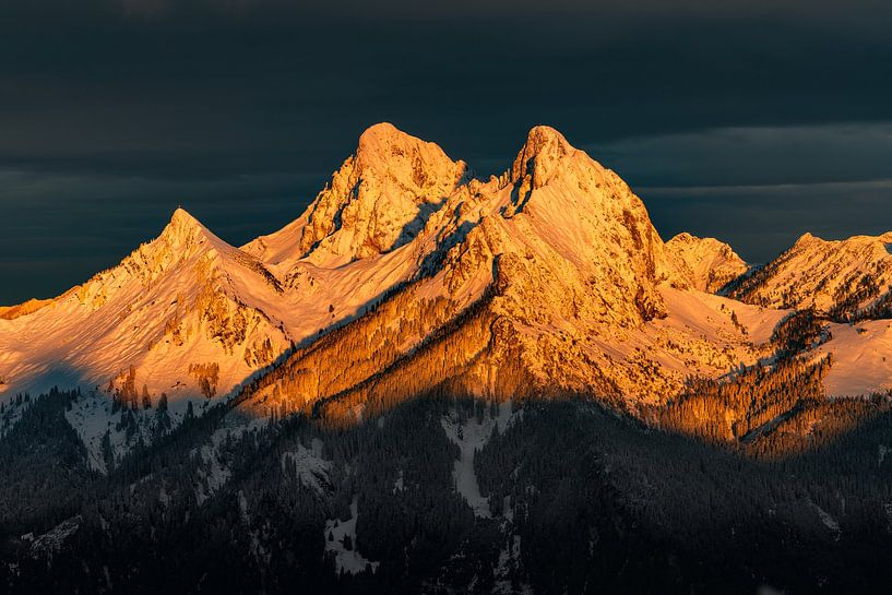 Red shining mountain in Tirol at sunrise. In winter with snow in the morning by Daniel Pahmeier