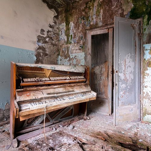 Piano abandonné dans un état de délabrement avancé.
