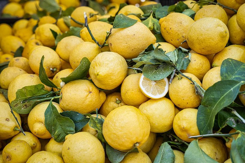 a pile of lemon for sale at a market by picsbyronenvief