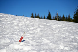 Red snow pole in deep snow by Tomherkules