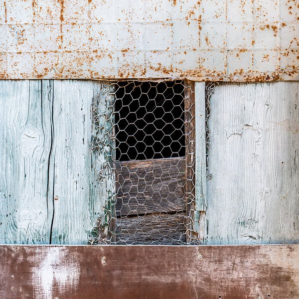 Detail of a partially boarded-up door in the village of Balazuc in France by Cindy Mulder