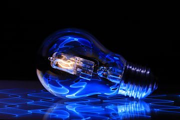 Burning light bulb with blue reflections by FotoBob