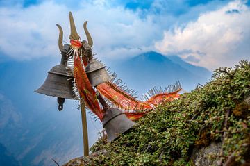 Trident (Trishula) with bells in Indian mountains. by Adri Vollenhouw