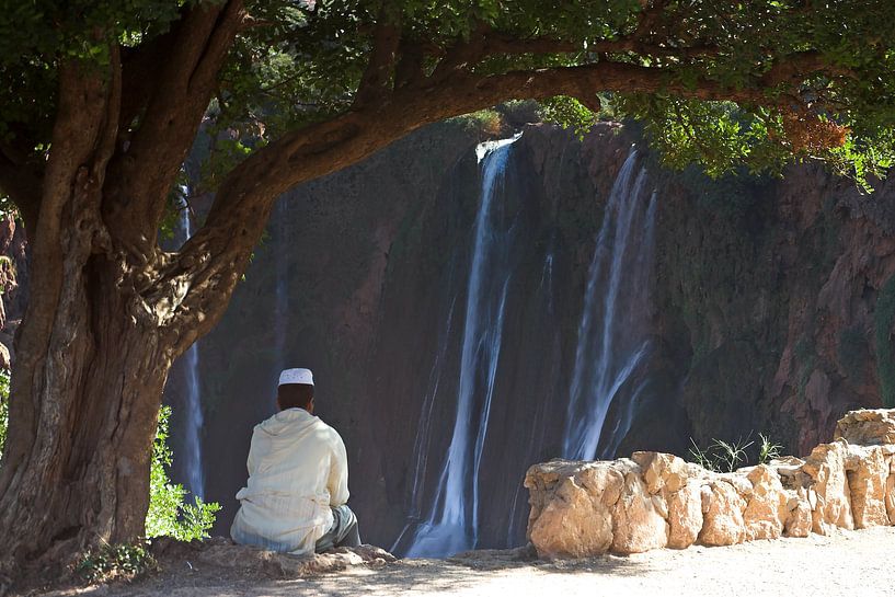 Young Moroccan man relaxes at the view of the Ouzoud Cascades by Dennis Wierenga