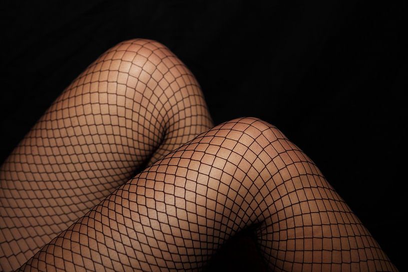Legs in net stockings by Frank Herrmann