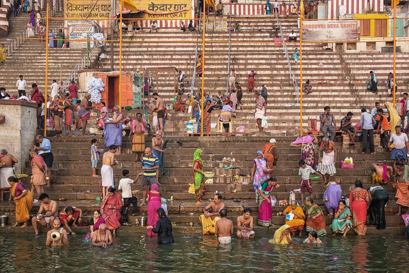 mensen nemen ritueel bad in de rivier de Ganges in de heilige stad Varanasi, India. van Tjeerd Kruse
