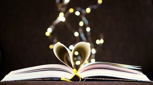 Opened book with pages, beaten to the heart