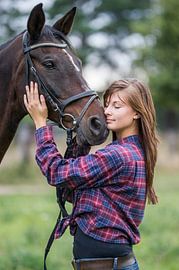 young woman with horse by Jörg B. Schubert