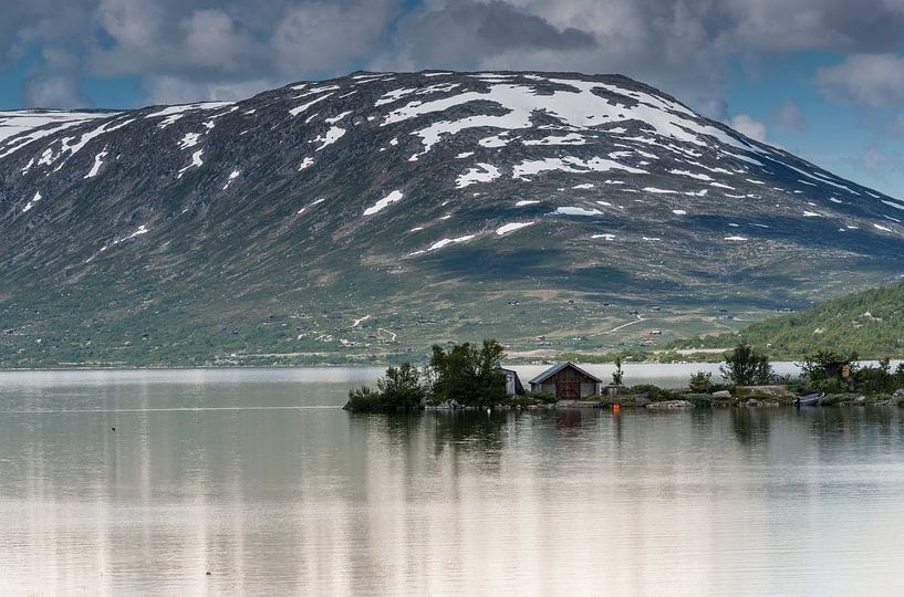 old house at a fjord with mountains with snow in the summer as background by ChrisWillemsen