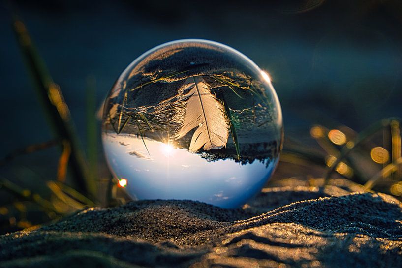 View through the glass ball on the beach. Sea and sky in background by Martin Köbsch