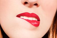 Young woman bites her lower lip