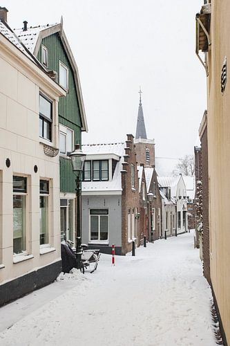 Village street with snow in Moordrecht Netherlands.