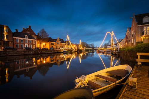 Dokkum by Night: Illuminated Boats and Historic Houses by the Canal