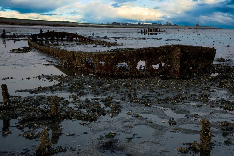 Sunset at the Wadden Sea with a shipwreck by Gert Hilbink