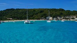 Paradise like turquoise water of greek island corfu bay and sailing ships by adventure-photos