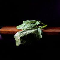 Photo of a beet leaf on wooden table