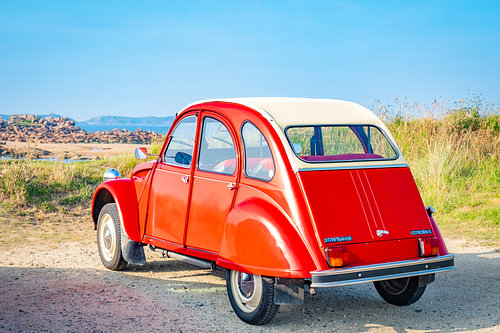 French classic Citroën 2CV car parked at the beach