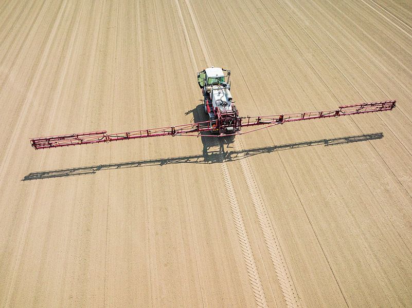 Agriculutural crops sprayer in a field seen from above by Sjoerd van der Wal Photography